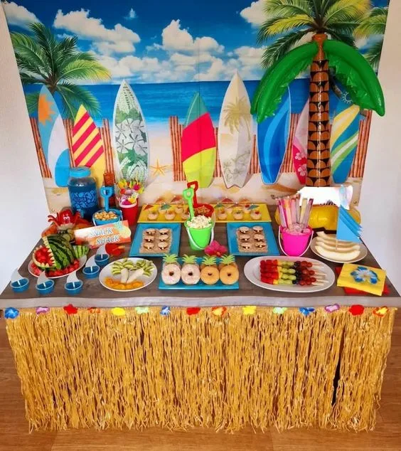 Beach Themed Birthday Snack Table With Hanging Fringes And Beach Printed Poster
