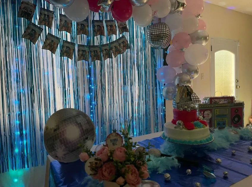 Mamma Mia Birthday Party Silver Fringe Curtain And Cake On Table