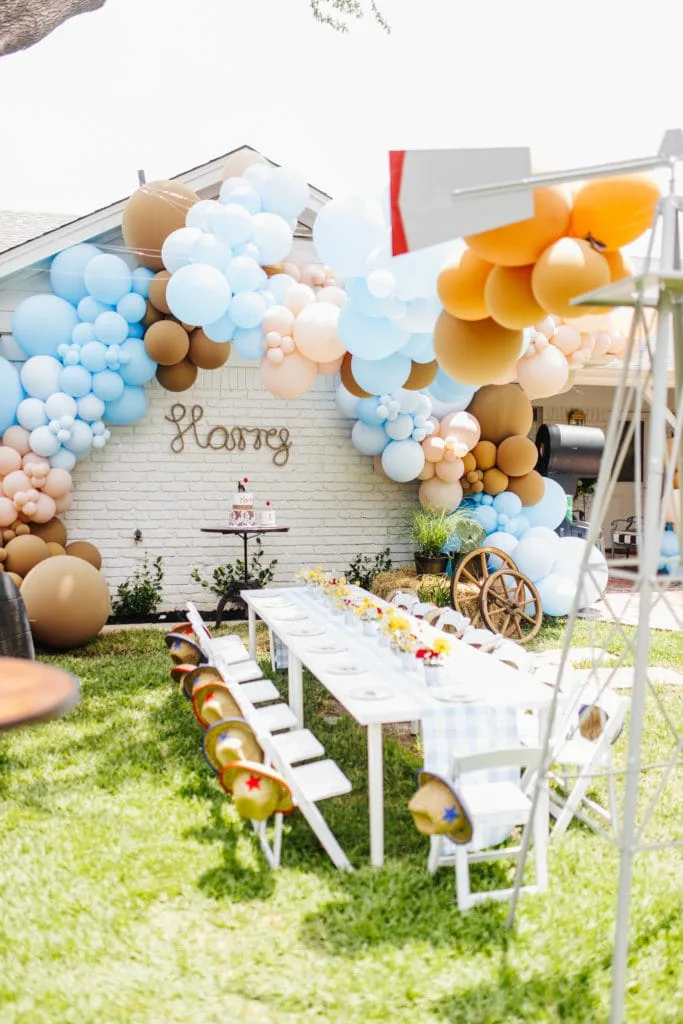 First Rodeo Birthday Party Outdoor Table Setting And Balloons Arches