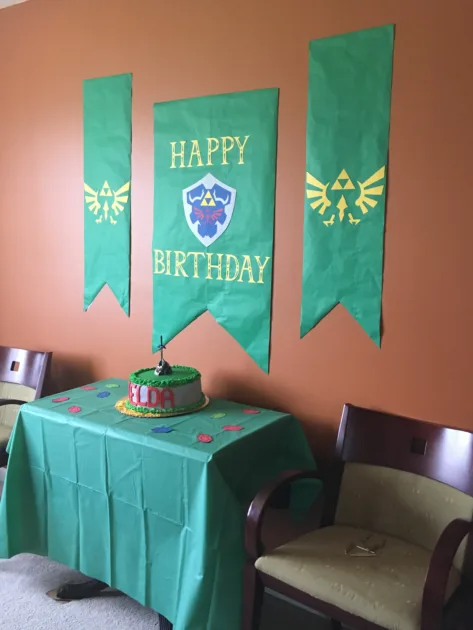 Zelda Birthday Decorations Green Banners And Green Tablecloth With Zelda Theme Cake