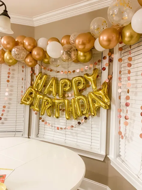 Gold Caps Rosegold Paper Garland Hanging Closed Window Blinds Side Angle View Gold Happy Birthday Balloons